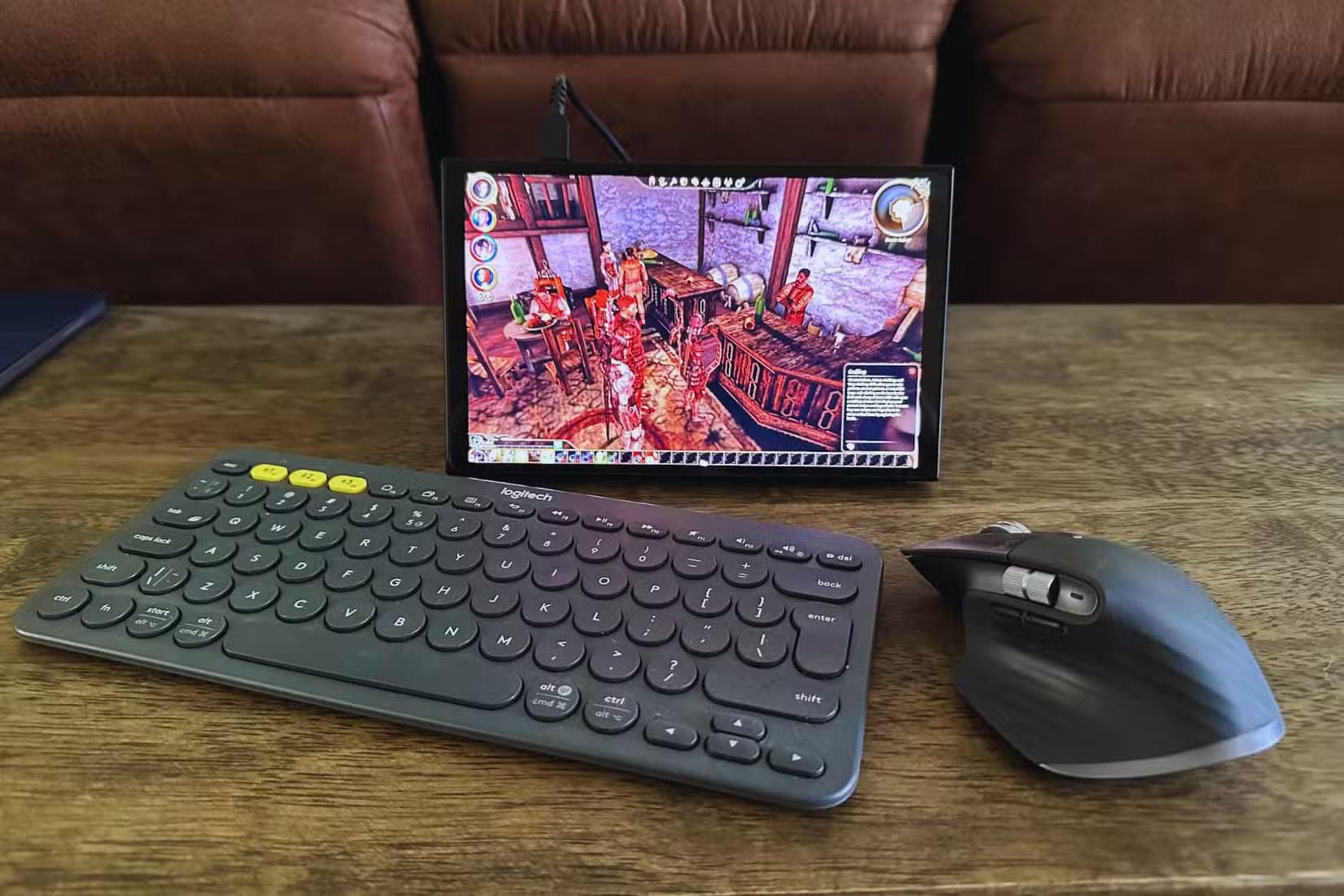 a-logitech-k380-keyboard-mx-master-3s-mouse-and-lenovo-legion-go-on-a-wooden-desk لماذا الاعتماد فقط على وحدة التحكم قد يحد من تجربة الألعاب لديك