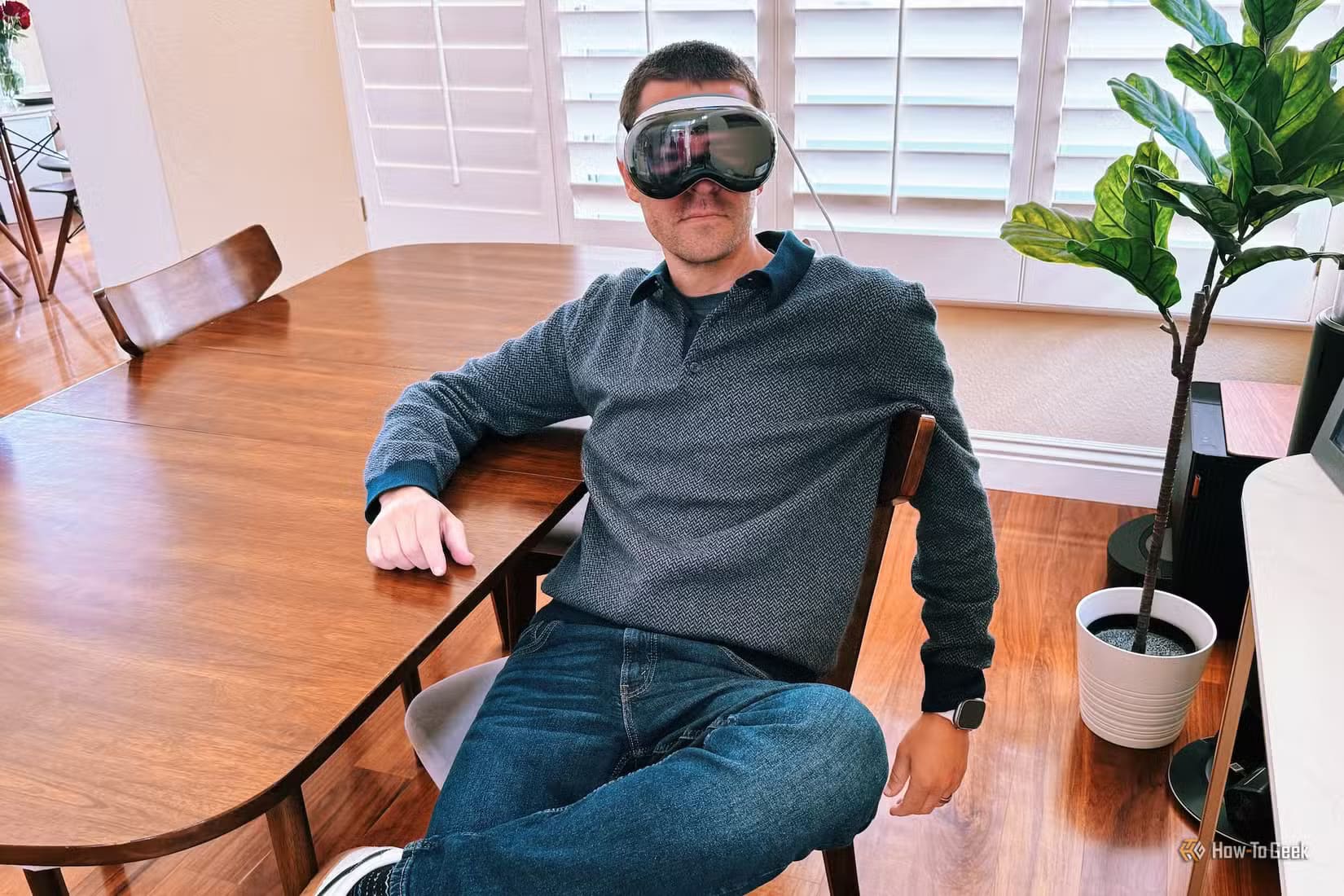 person-wearing-an-apple-vision-pro-sitting-on-a-chair أحدث منتجات Apple المتوقعة التي قد تغير تجربتك التكنولوجية